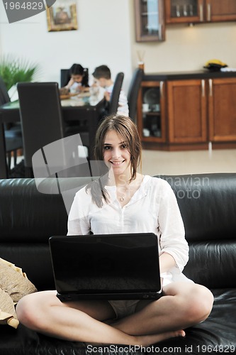 Image of happy young family have fun and working on laptop at home