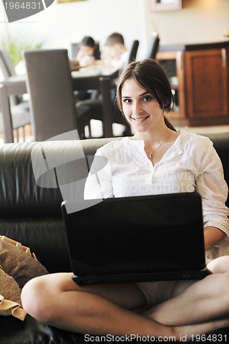 Image of happy young family have fun and working on laptop at home
