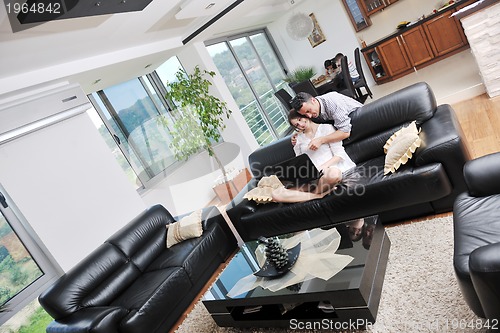 Image of happy young family have fun and working on laptop at home