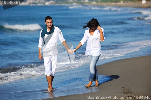 Image of happy young couple have fun at beautiful beach