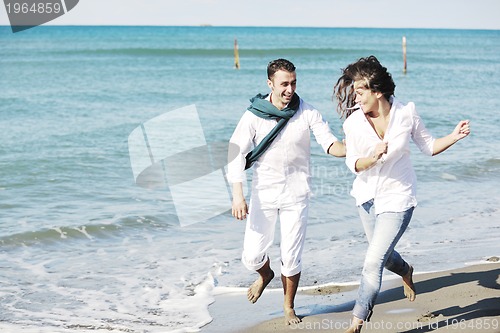 Image of happy young couple have fun at beautiful beach