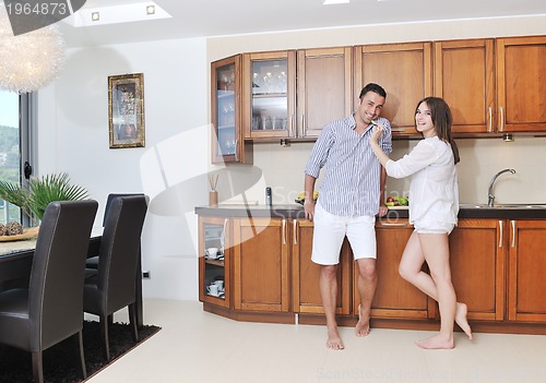 Image of happy young couple have fun in modern kitchen
