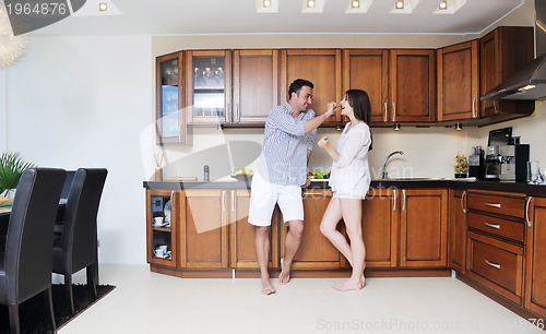 Image of happy young couple have fun in modern kitchen