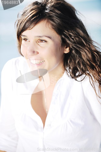 Image of happy young woman on beach
