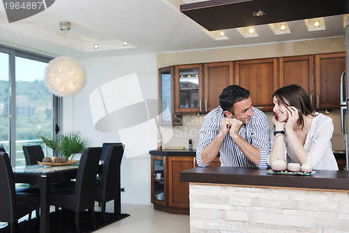 Image of happy young couple have fun in modern kitchen