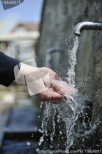 Image of fresh mountain water falling on hands