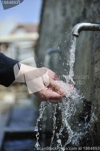 Image of fresh mountain water falling on hands