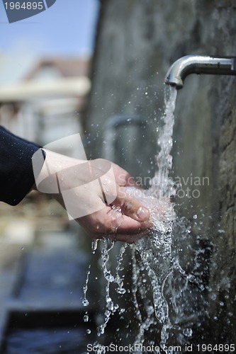Image of fresh mountain water falling on hands