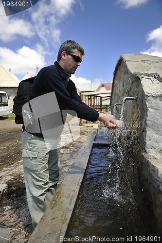 Image of fresh mountain water falling on hands