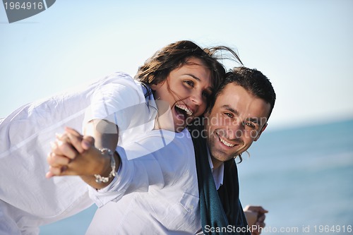Image of happy young couple have fun at beautiful beach