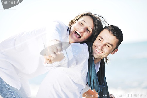 Image of happy young couple have fun at beautiful beach