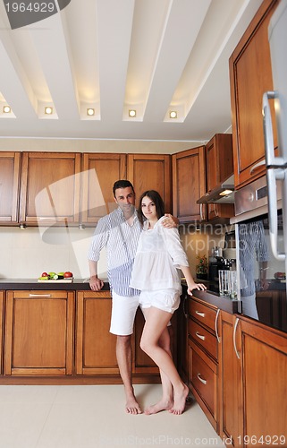 Image of happy young couple have fun in modern kitchen