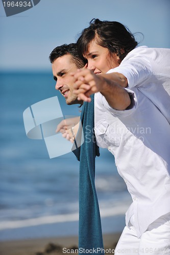 Image of happy young couple have fun at beautiful beach