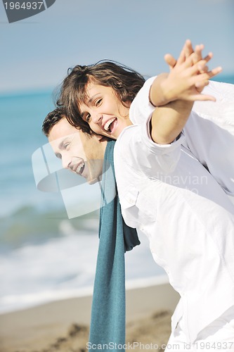 Image of happy young couple have fun at beautiful beach