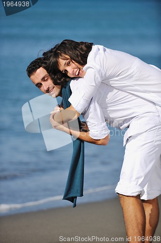 Image of happy young couple have fun at beautiful beach