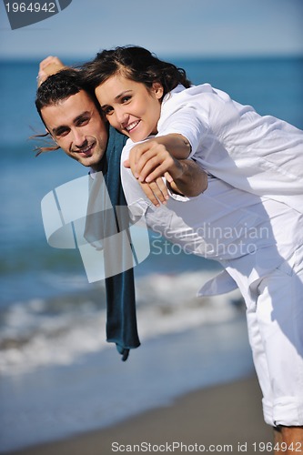 Image of happy young couple have fun at beautiful beach
