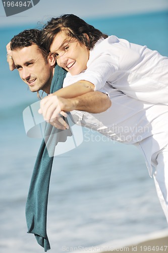 Image of happy young couple have fun at beautiful beach