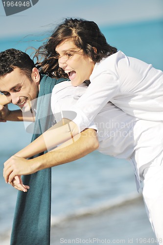 Image of happy young couple have fun at beautiful beach