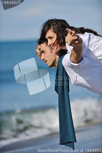 Image of happy young couple have fun at beautiful beach