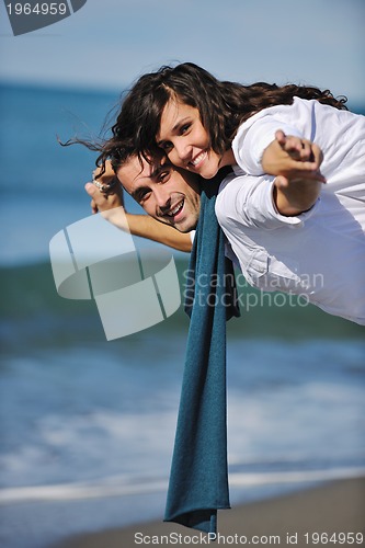 Image of happy young couple have fun at beautiful beach