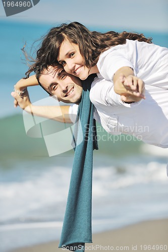 Image of happy young couple have fun at beautiful beach