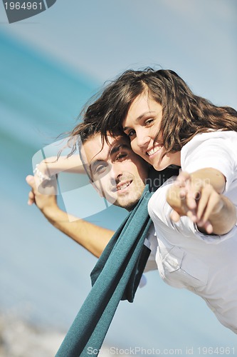 Image of happy young couple have fun at beautiful beach