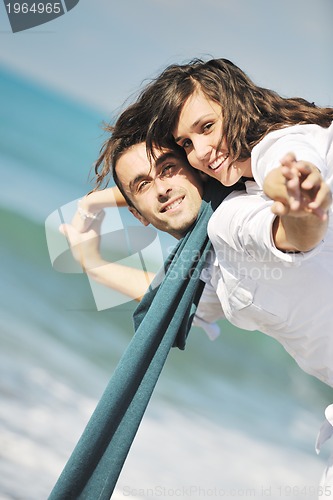Image of happy young couple have fun at beautiful beach