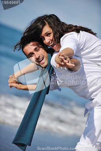 Image of happy young couple have fun at beautiful beach