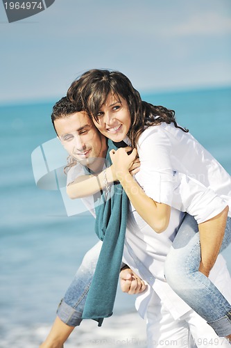 Image of happy young couple have fun at beautiful beach