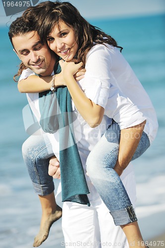 Image of happy young couple have fun at beautiful beach