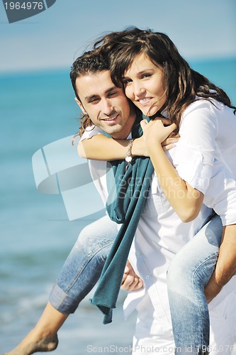 Image of happy young couple have fun at beautiful beach