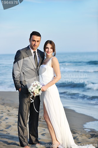 Image of romantic beach wedding at sunset
