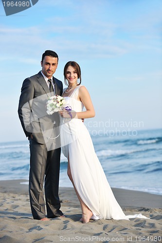 Image of romantic beach wedding at sunset