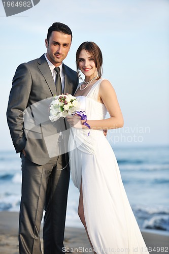 Image of romantic beach wedding at sunset