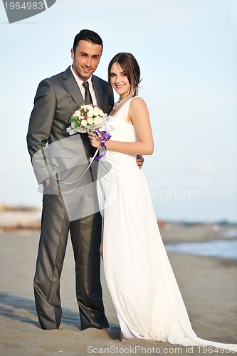 Image of romantic beach wedding at sunset