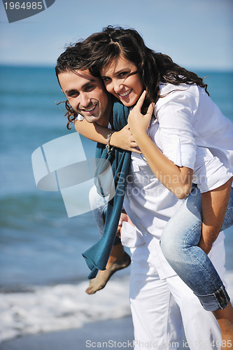 Image of happy young couple have fun at beautiful beach
