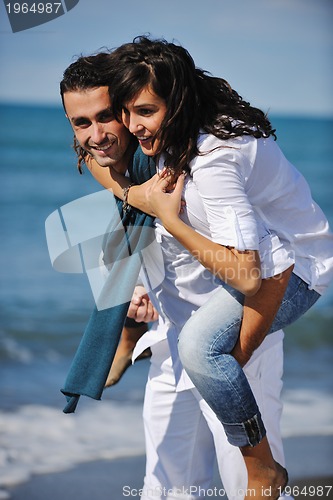 Image of happy young couple have fun at beautiful beach
