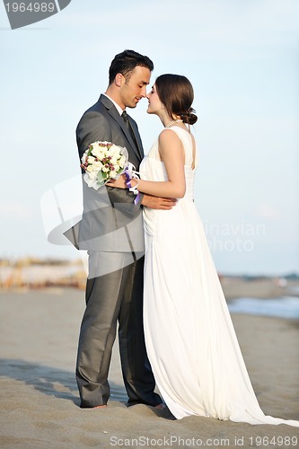 Image of romantic beach wedding at sunset