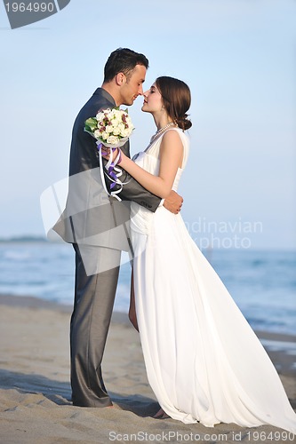 Image of romantic beach wedding at sunset