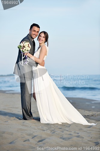 Image of romantic beach wedding at sunset