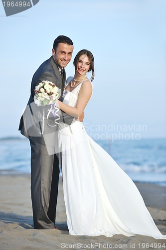 Image of romantic beach wedding at sunset