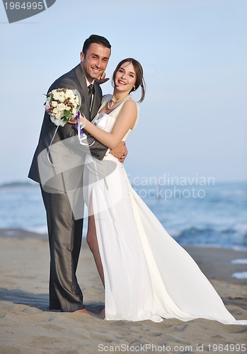 Image of romantic beach wedding at sunset