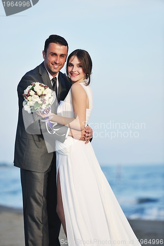 Image of romantic beach wedding at sunset