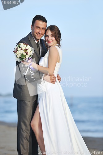 Image of romantic beach wedding at sunset