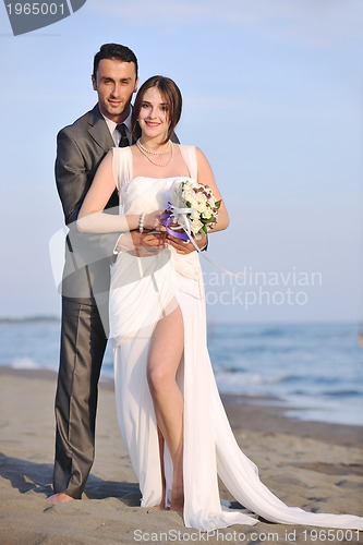 Image of romantic beach wedding at sunset