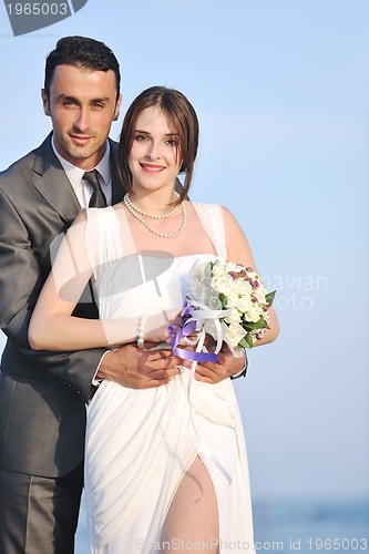 Image of romantic beach wedding at sunset