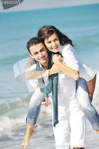 Image of happy young couple have fun at beautiful beach