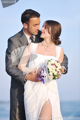 Image of romantic beach wedding at sunset