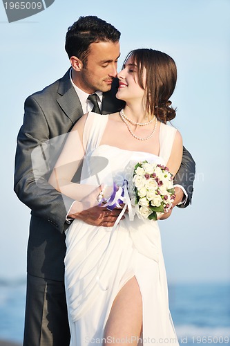 Image of romantic beach wedding at sunset