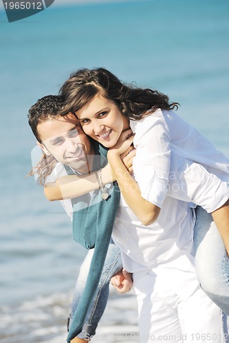 Image of happy young couple have fun at beautiful beach
